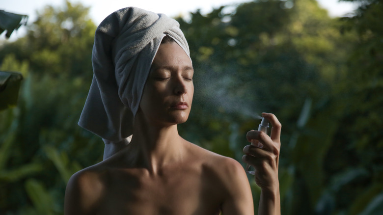 woman applying face mist