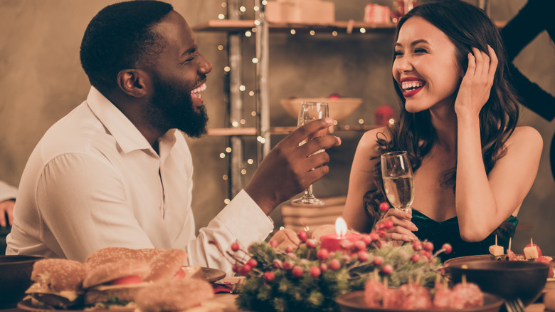 laughing couple having dinner