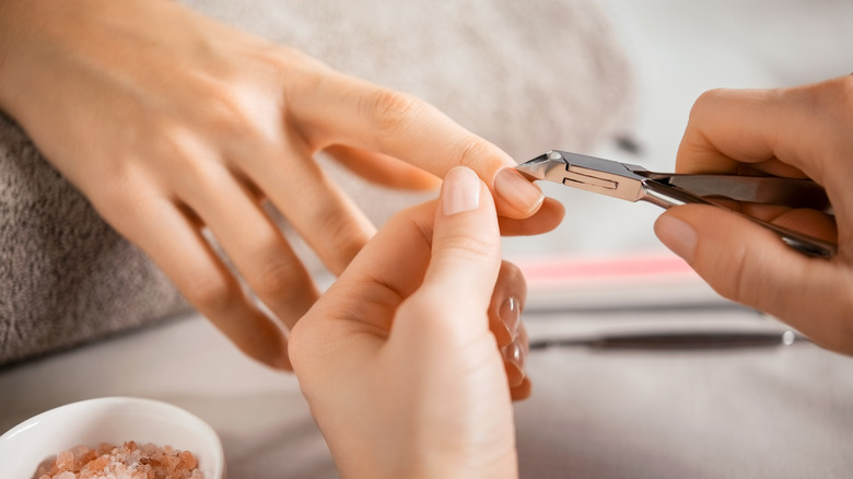 woman using cuticle clipper