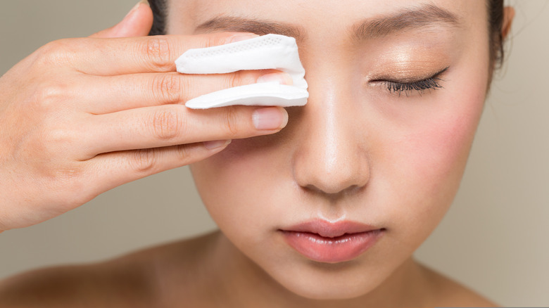 woman removing eye makeup