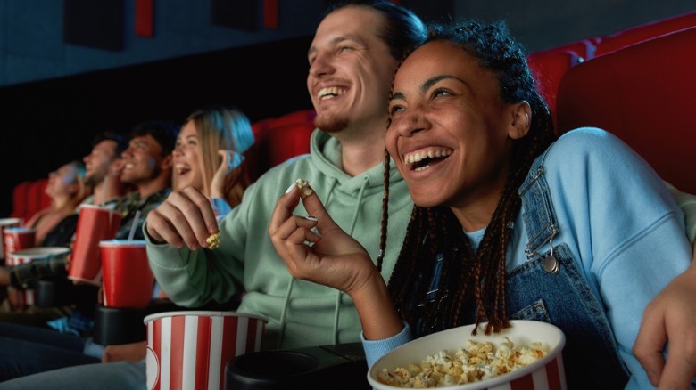 Couple laughing at movie theater