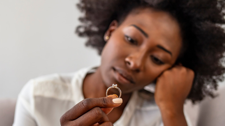 woman holding wedding ring