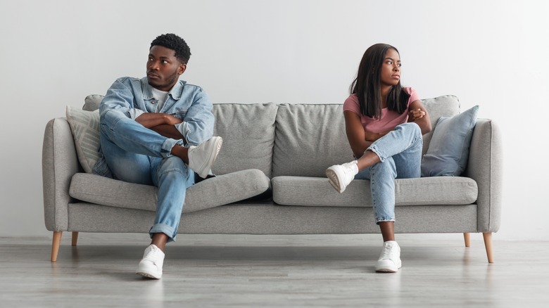 angry couple on sofa not talking