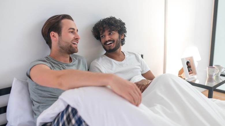 couple in bed smiling