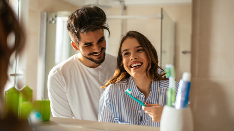 Couple brushing teeth