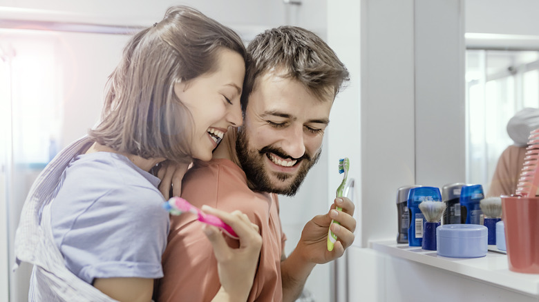 Husband and wife brushing teeth