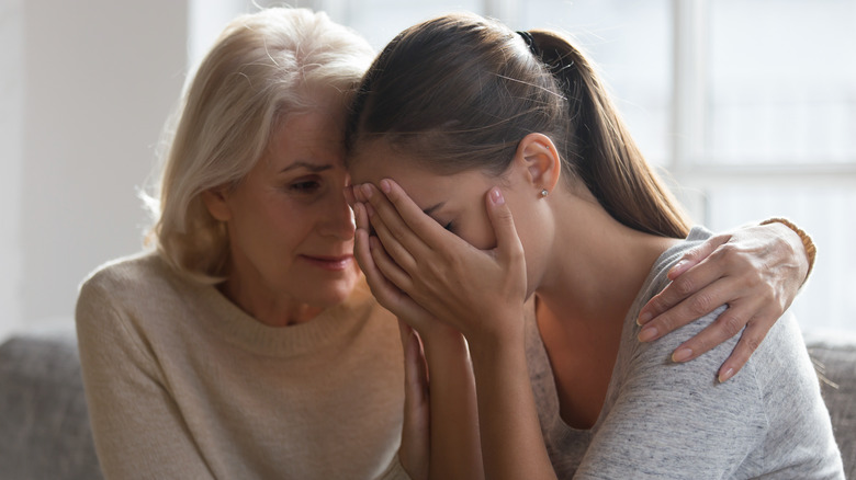 mother comforting worried daughter