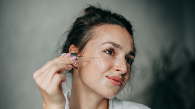 woman applying serum