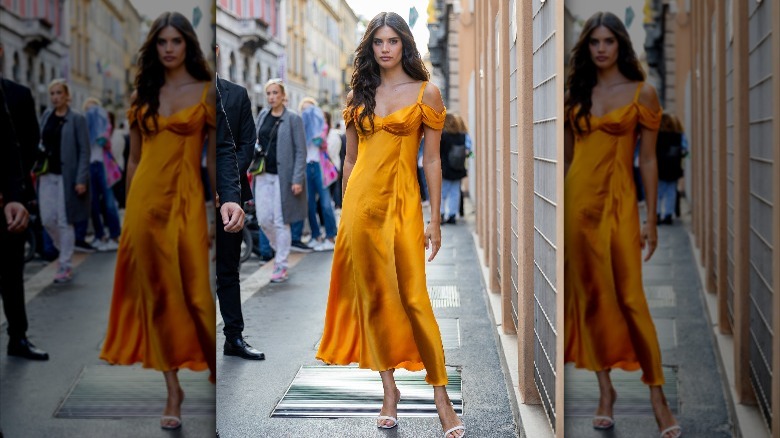 Woman in dark yellow satin dress