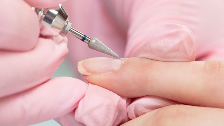 technician filing down nail