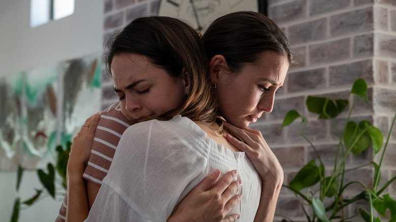 woman providing support and hugging