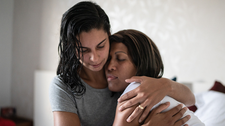 woman providing support and hug