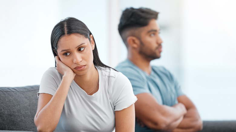 Unhappy couple on sofa