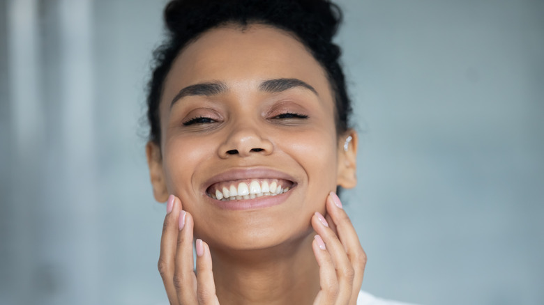 Woman touching her face