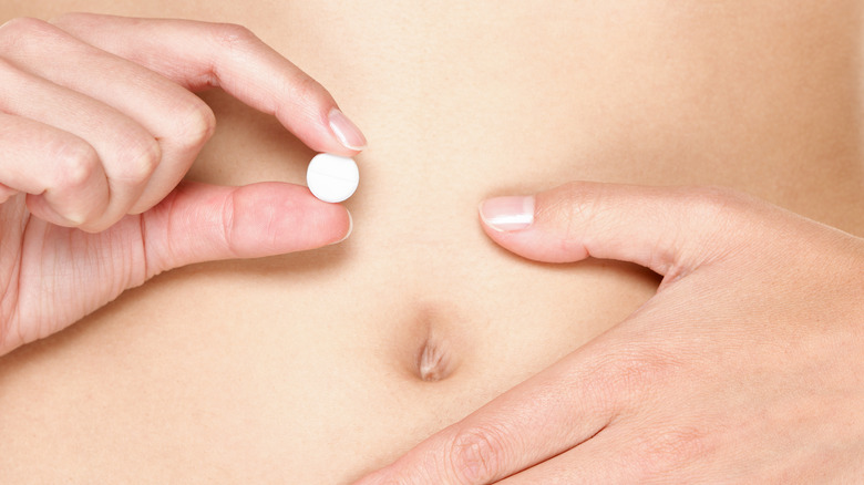 woman holding plan b pill 