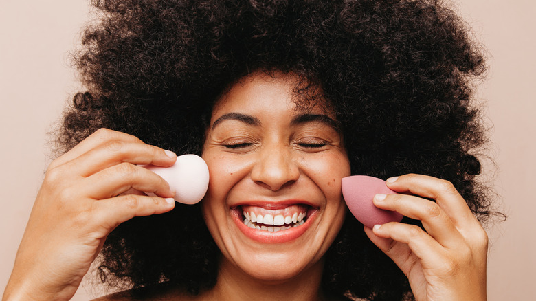 Black woman with makeup sponges