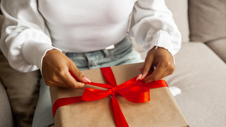 woman wrapping gift 