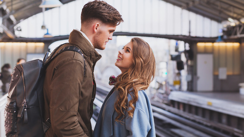 man and woman at railway station