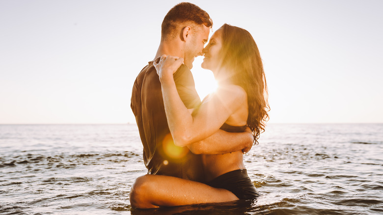 man and woman bathing in sea