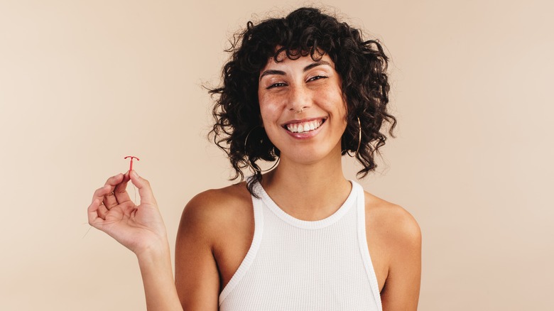 Woman holding an IUD 