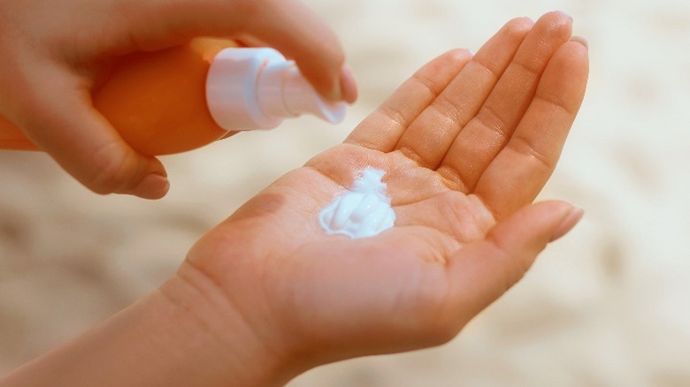 Sunscreen getting pumped onto hand