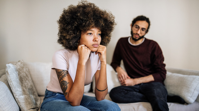 Unhappy couple on sofa