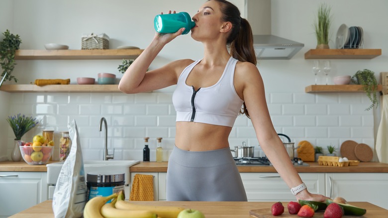 woman drinking in kitchen 