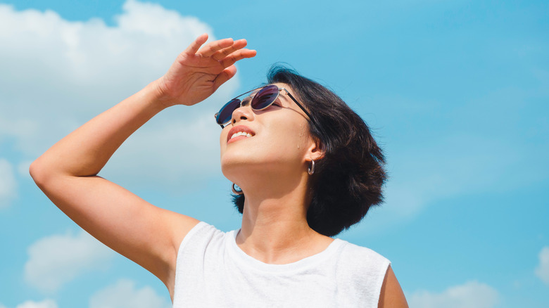 woman sunglasses looking at sky 