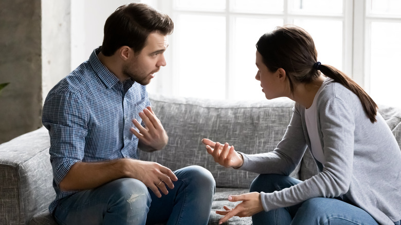 Couple arguing on sofa