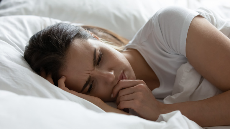 Person feeling distressed in bed