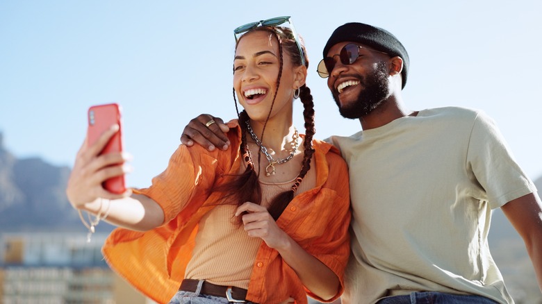 man and woman taking selfie