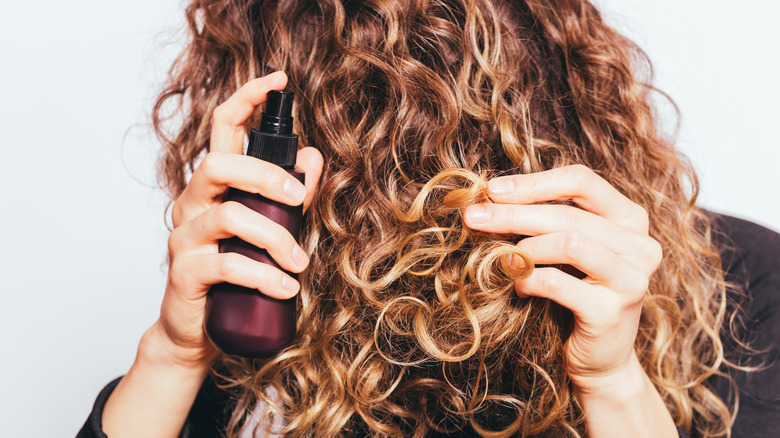 woman applying hair product