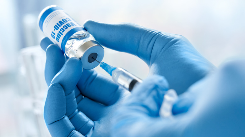 Provider obtaining COVID-19 vaccine from vial