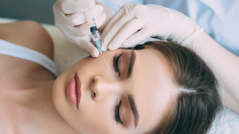 Woman receives Botox injections underneath her eye