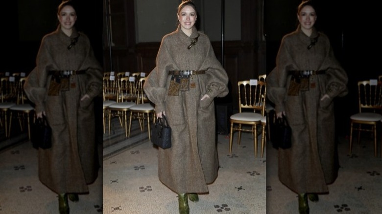 Woman with long coat and belt bag