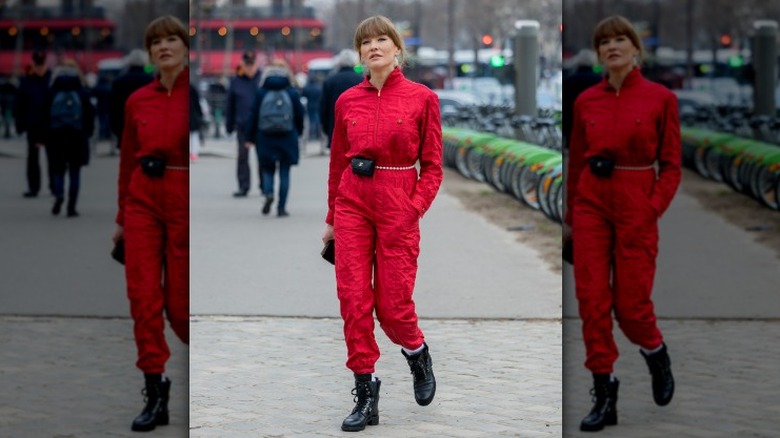 Woman wearing a red jumpsuit and a chanel belt bag