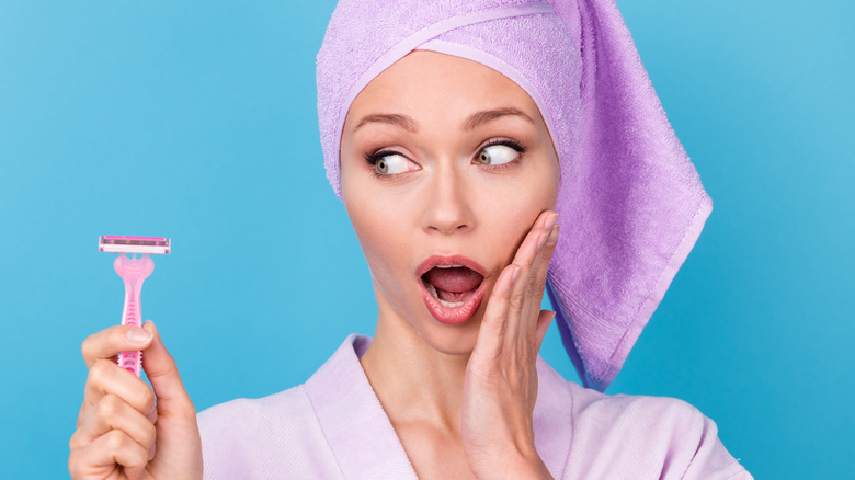 Shocked model holding razor