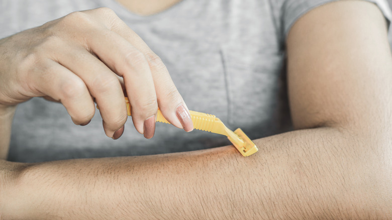 Model shaving arm hair 