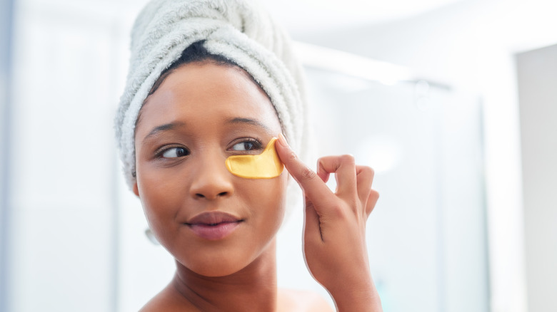 woman applying eye cream