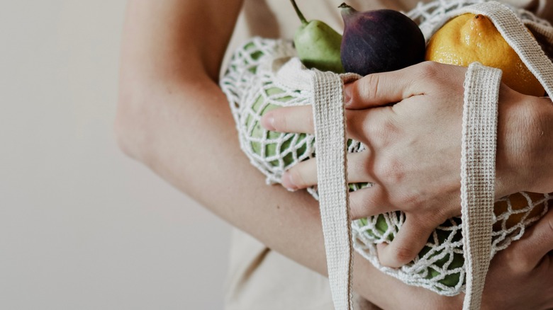 woman holding back of healthy food