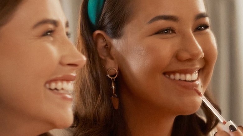 Girls laughing and wearing lipstick