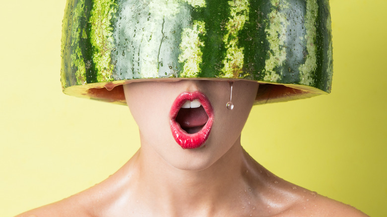 woman with a watermelon on her head