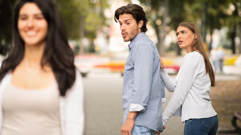 man checking out other woman