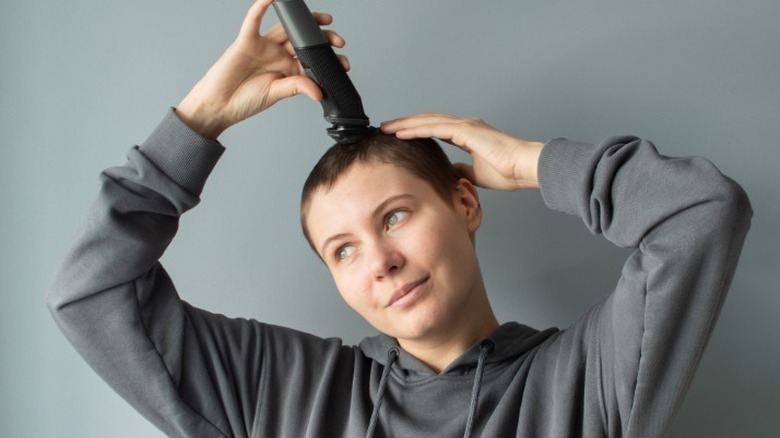 Woman shaving her head