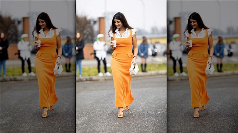 woman wearing bright orange midi dress 