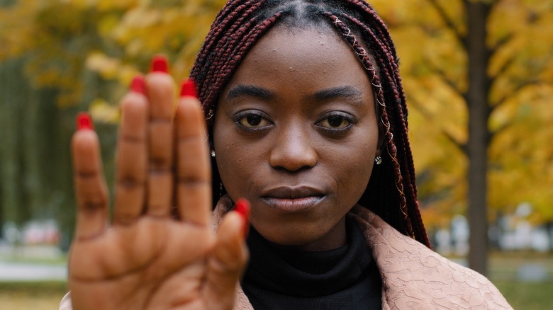 Woman holding hand up in stop gesture