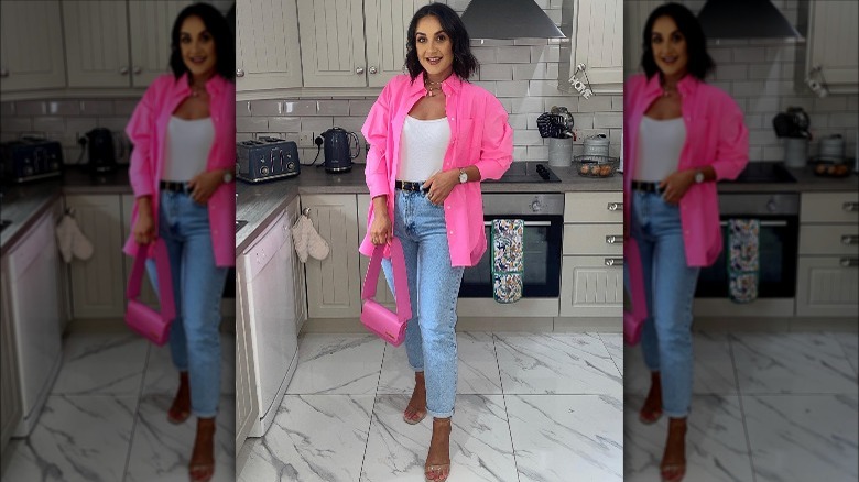 Woman wearing jeans, heels, pink