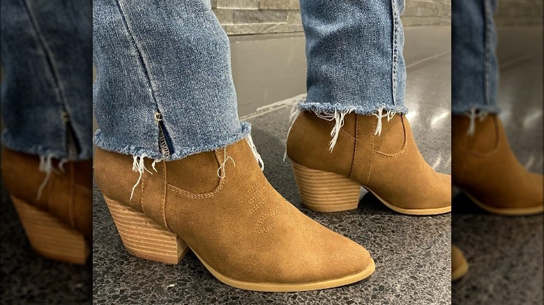 Woman wearing jeans, western booties