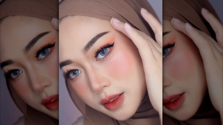 Glamorous woman wearing headscarf and makeup