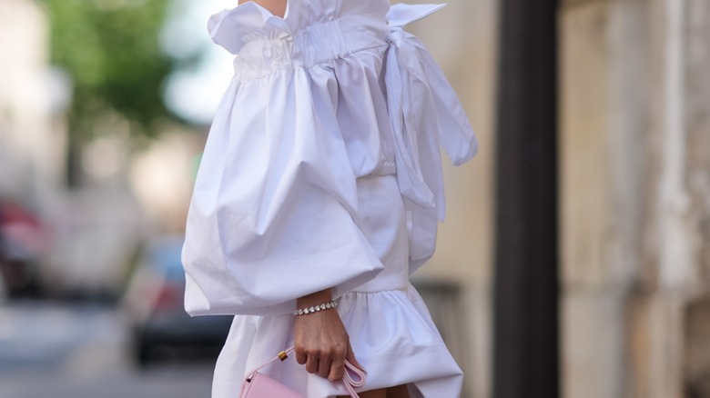 Woman in white wearing diamond bracelet